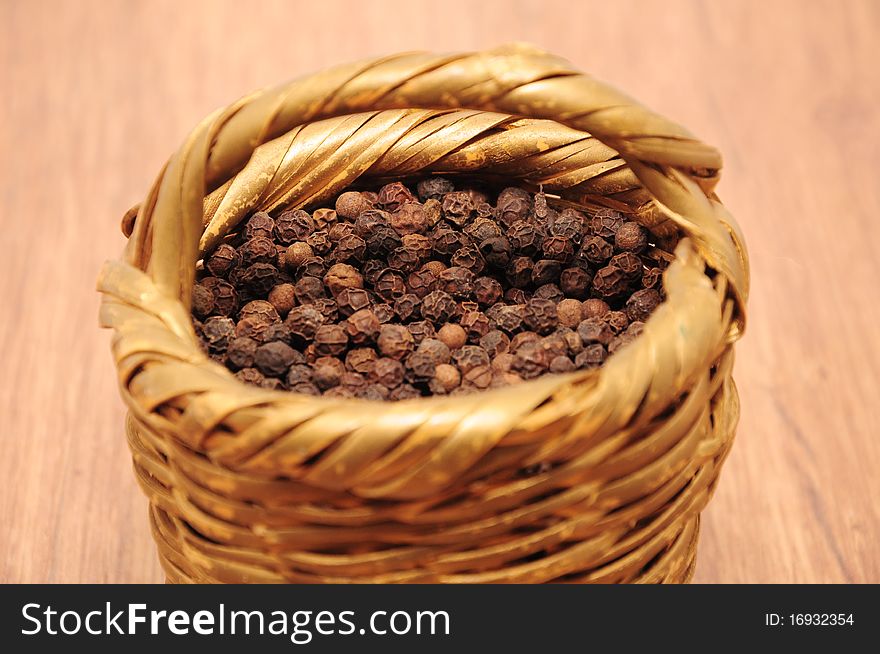 Peppercorns in a wicker basket. Peppercorns in a wicker basket