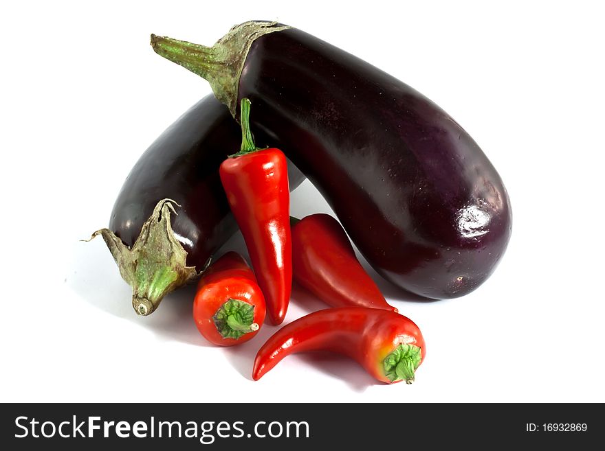 Eggplants and fresno peppers on a white background. Eggplants and fresno peppers on a white background