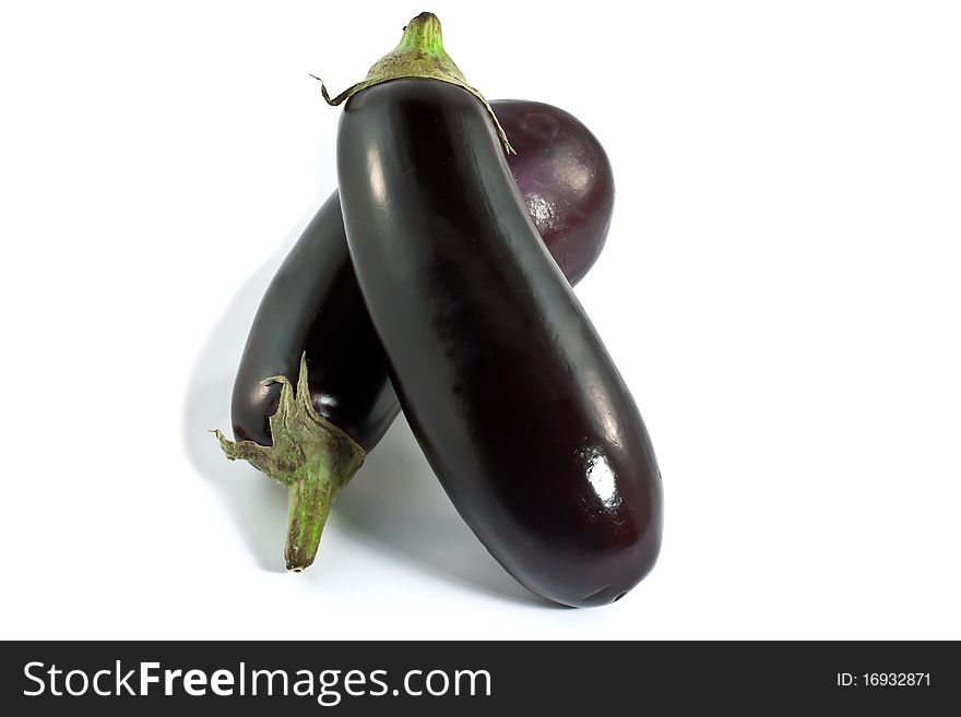 Two purple eggplants on a white background