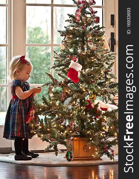 Little Girl Waiting for Santa in front of a Christmas Tree