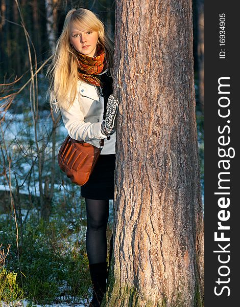 Blonde Peers Out For Stem Tree In Autumn Wood