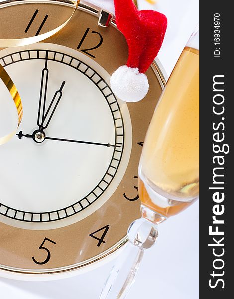 The clock showed almost 12.00 in the Santa hat and champagne. The clock showed almost 12.00 in the Santa hat and champagne