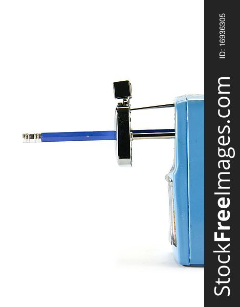 Pencil sharpener with blue pencil on white background