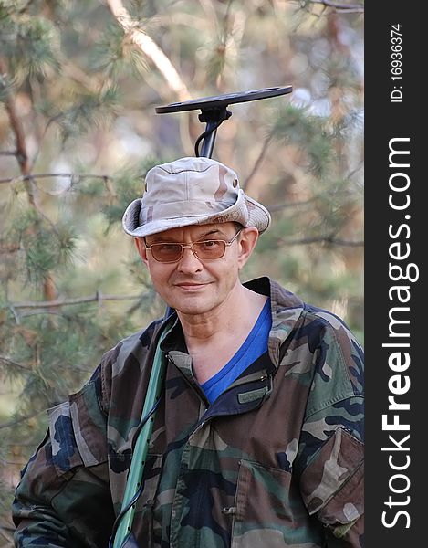 Military archeology. Man with metal detector on the battlefield of WW2.Ukraine