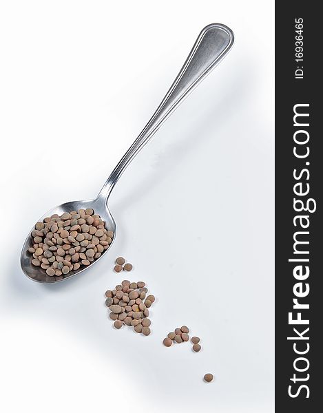 full tablespoon of lentils with white bottom. full tablespoon of lentils with white bottom