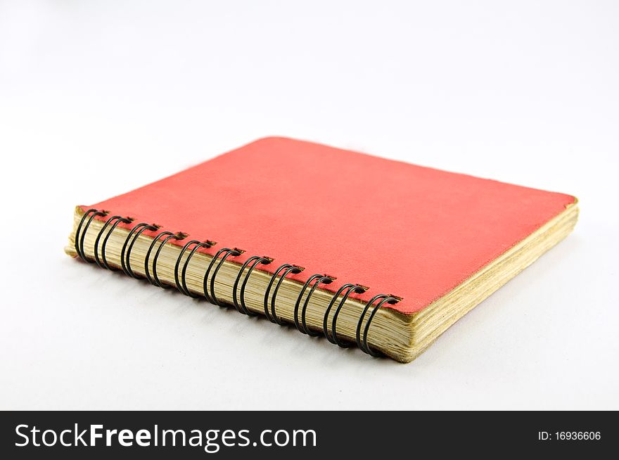 Old Red Spiral Notebook on white background
