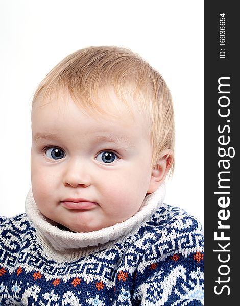 Portrait of confused baby in switter on a white isolated background