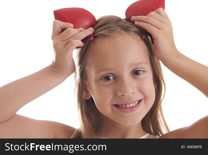 Girl holds red heart on her head on white background. Girl holds red heart on her head on white background