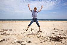 Boy Enjoys The Beautiful Beach And Jumps Royalty Free Stock Image Boy Enjoys The Beautiful Beach And Jumps Royalty Free Stock Image