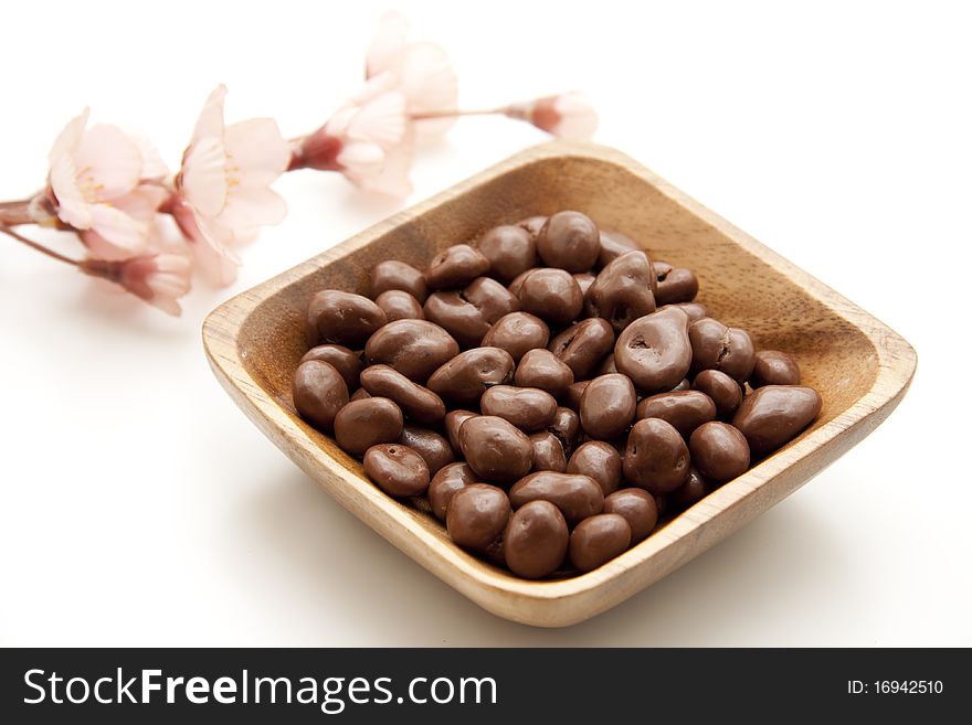 Raisins chocolate in the wood bowl. Raisins chocolate in the wood bowl