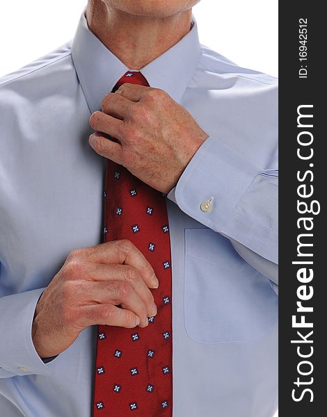 Businessman fixing his tie isolated on a white background