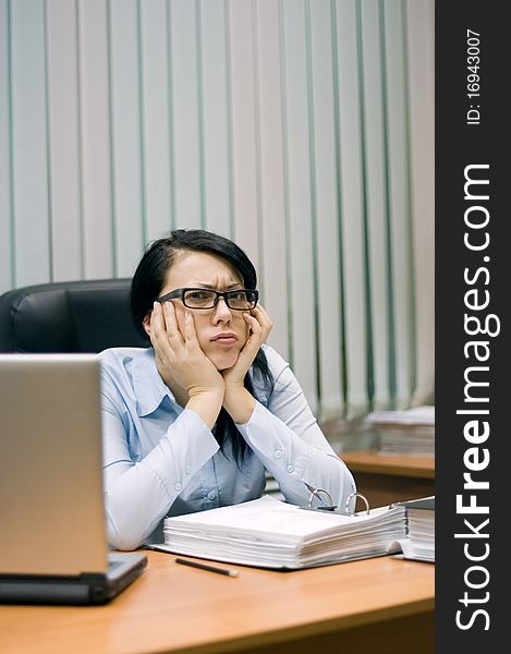 Young girl at office behind a table