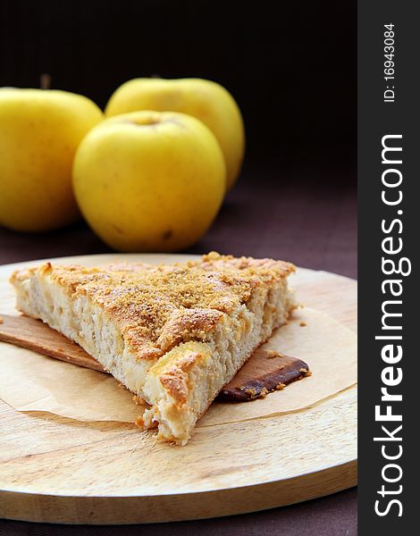 Slice of apple pie on a wooden board