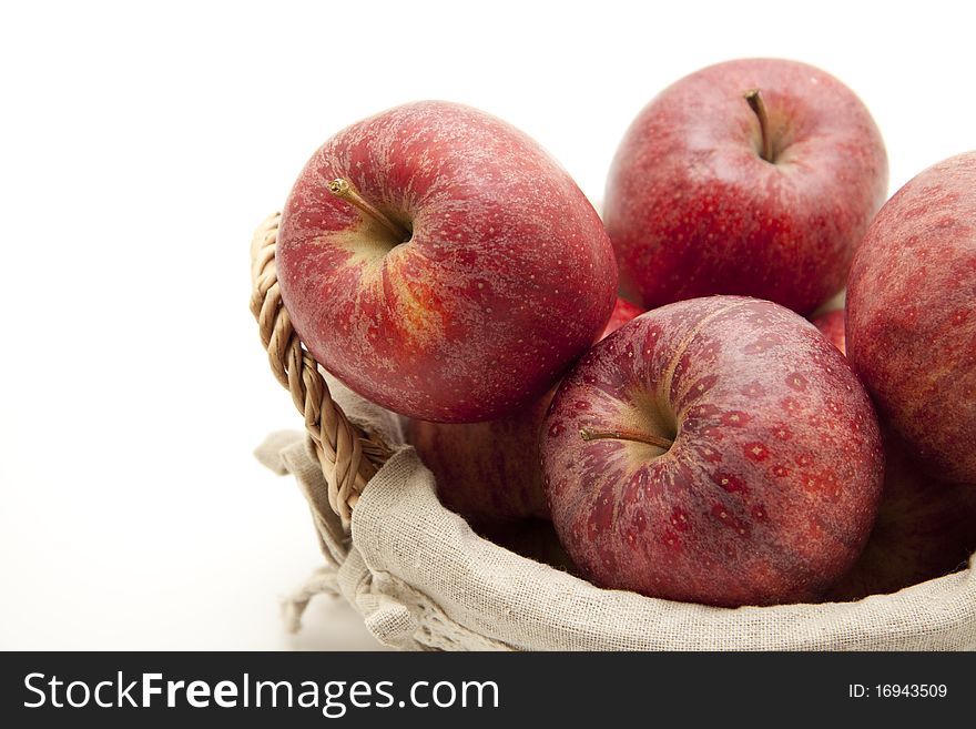 Red apples in the basket with material