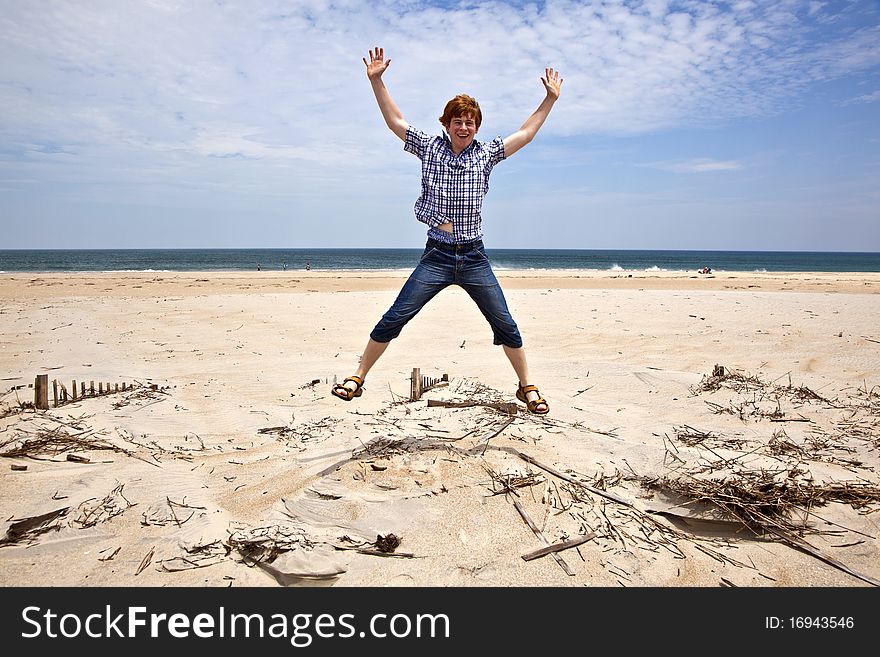 Cute boy enjoys the beautiful beach and jumps. Cute boy enjoys the beautiful beach and jumps