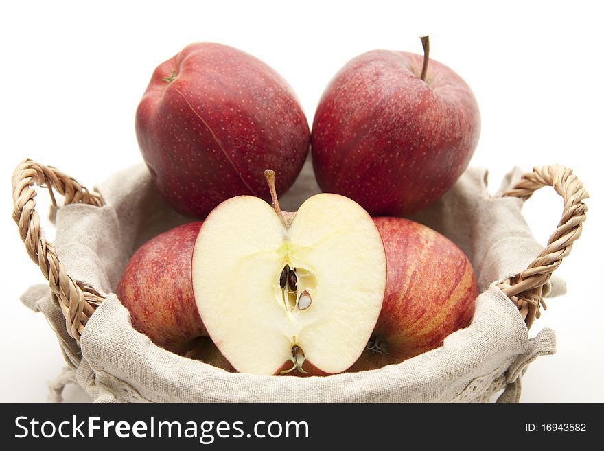 Halved apple and whole apples in the basket