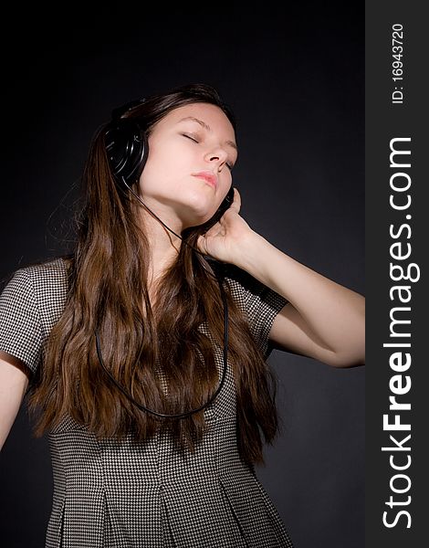 Beautiful woman in headphones listening music, studio shot. Beautiful woman in headphones listening music, studio shot