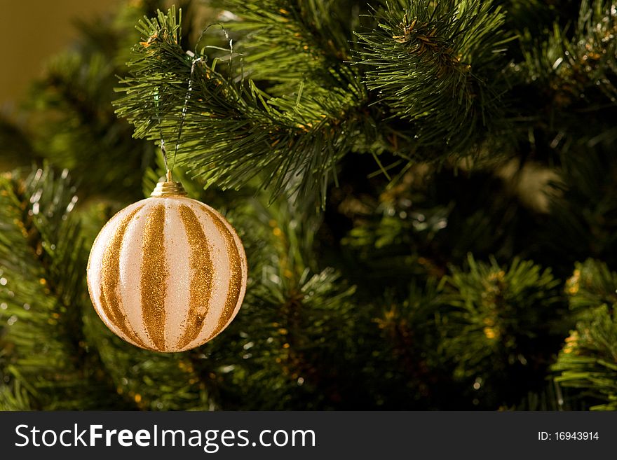 Christmas tree with one gold ornament ball