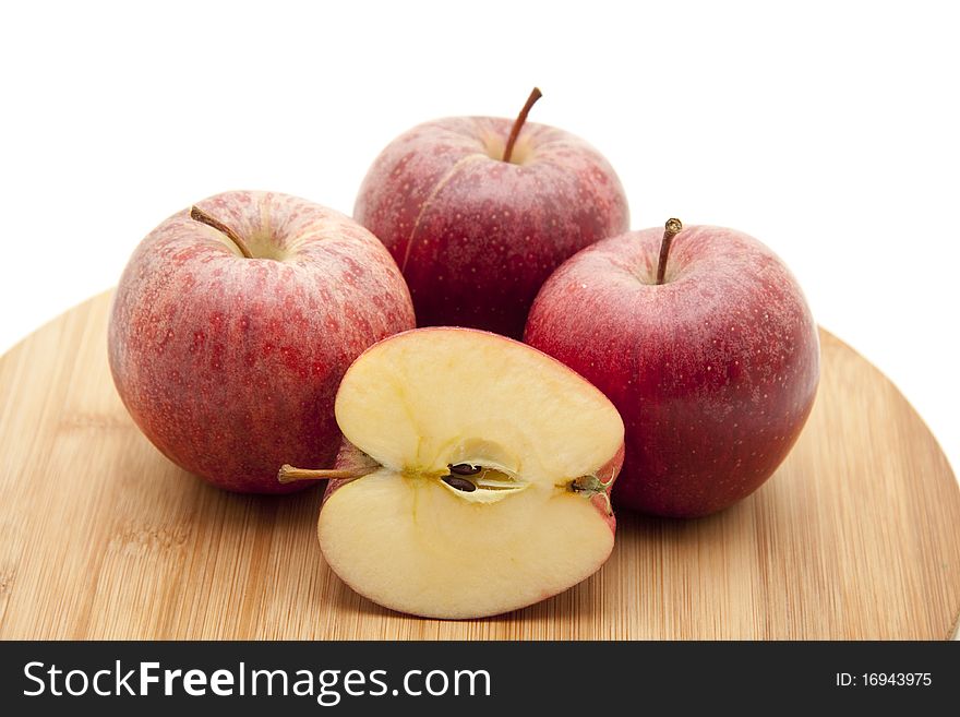 Halved apple and whole apples on edge board