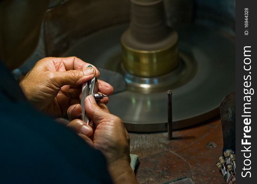 Worker polishing a gem stone. Worker polishing a gem stone
