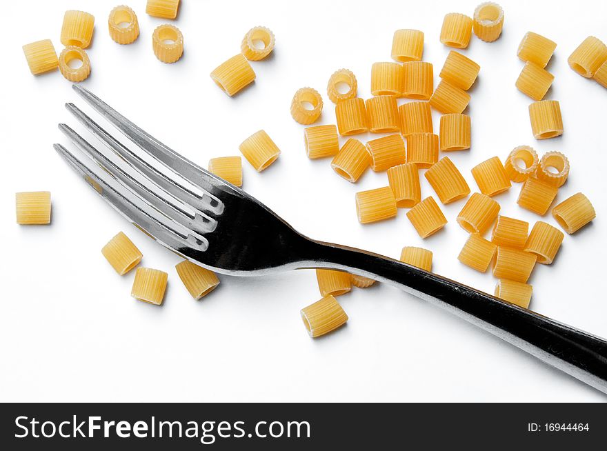 Pasta and fork on white background