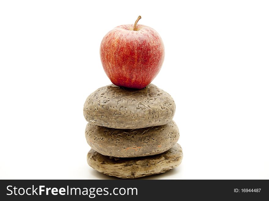 Red apple onto stacked stones