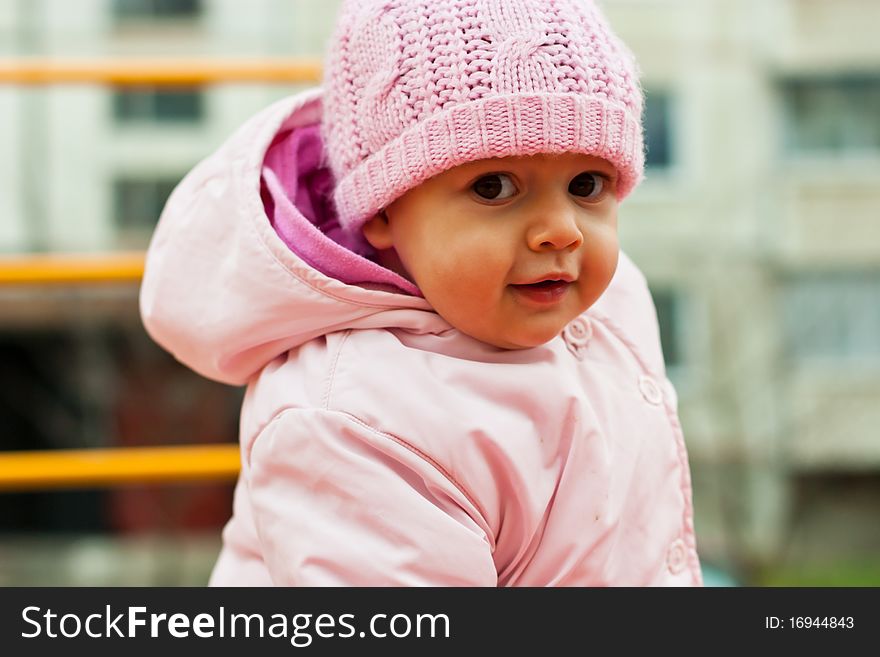 Beautiful baby smiling outdoor in playground. Beautiful baby smiling outdoor in playground