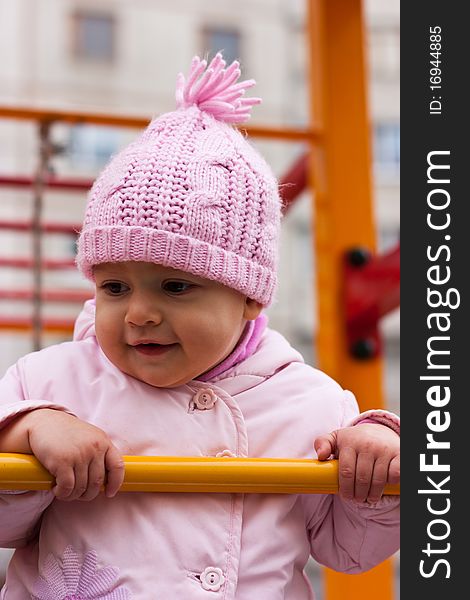 Beautiful baby smiling outdoor in playground. Beautiful baby smiling outdoor in playground