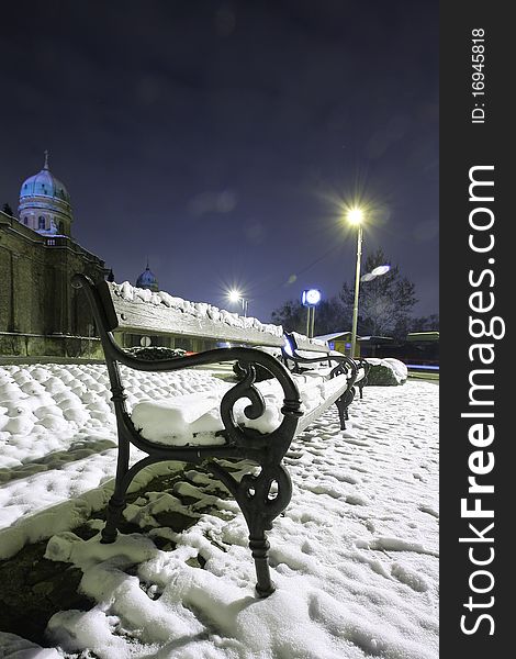 Snow on the bench in the park