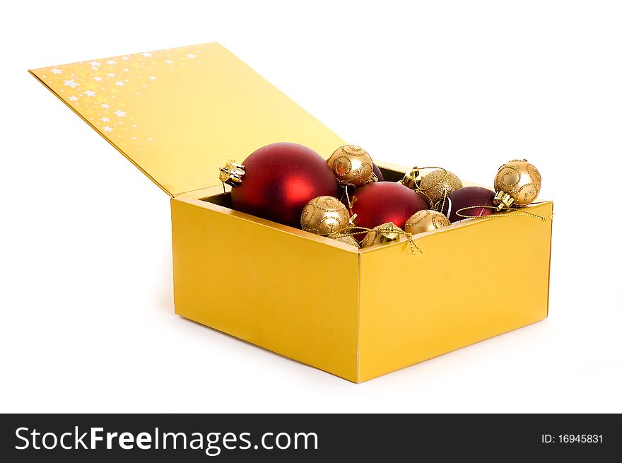 Golden box with christmas balls isolated on white background. Golden box with christmas balls isolated on white background