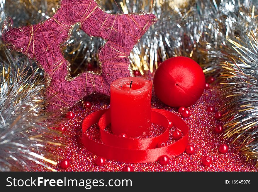 Extinguished red candle with christmas decorations