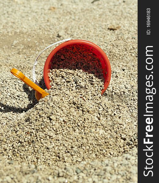 Bucket in the sand on the sea coast