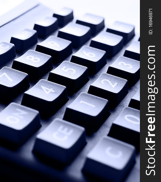 Buttons close up of the calculator with dark blue toning. Buttons close up of the calculator with dark blue toning