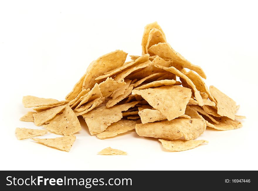 A pile of mexican nachos on white background. A pile of mexican nachos on white background