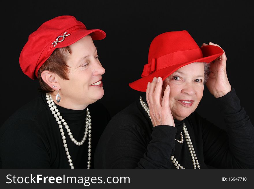 Adult mother and daughter wearing red hats