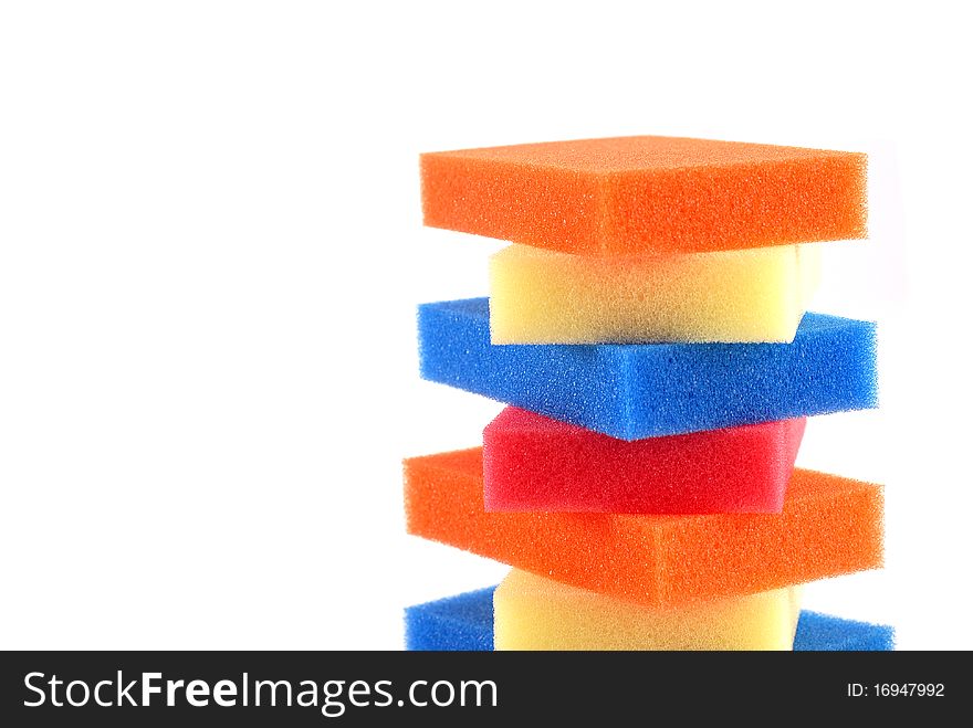 Stack of colorful sponges on a white background. Stack of colorful sponges on a white background