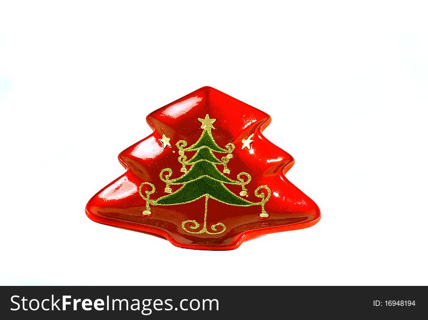 Red christmas plate shaped as a tree with glitter tree decoration. Red christmas plate shaped as a tree with glitter tree decoration