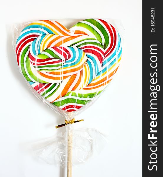 Close up of colourful lollipop, heart shape. Close up of colourful lollipop, heart shape.