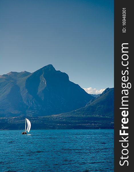 Sailboat at Lake Garda with mountains on the back. Sailboat at Lake Garda with mountains on the back