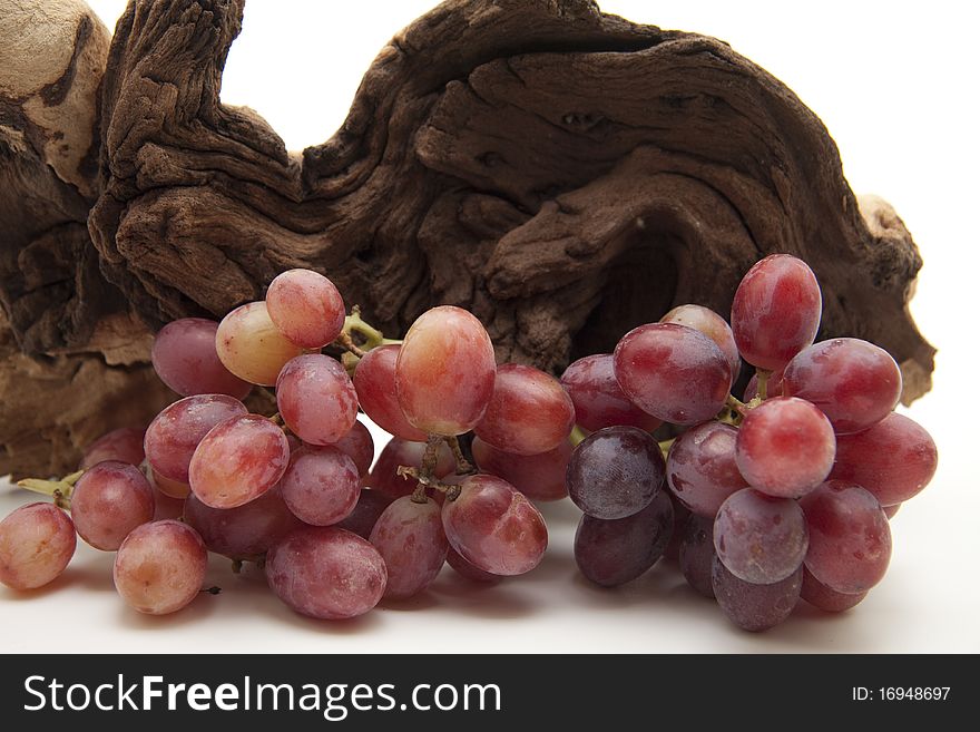 Red grapes in front of old root. Red grapes in front of old root