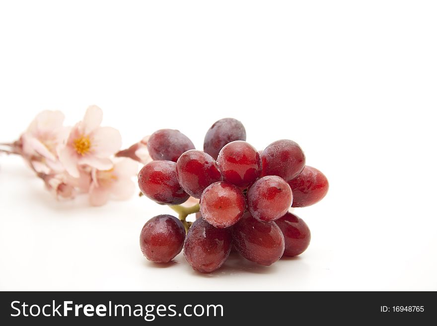 Red grapes with flower blossoms