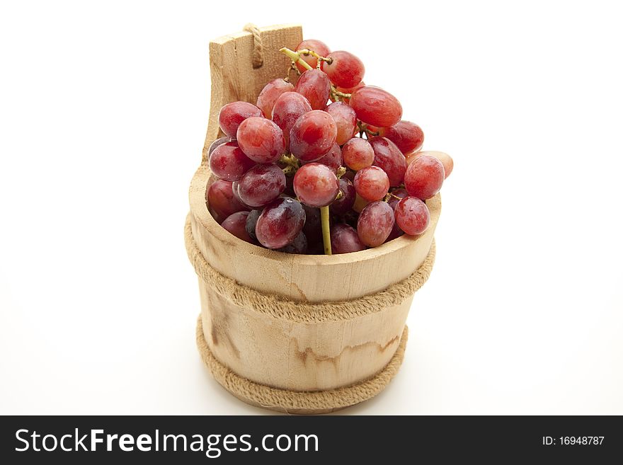 Red grapes in the wood receptacle