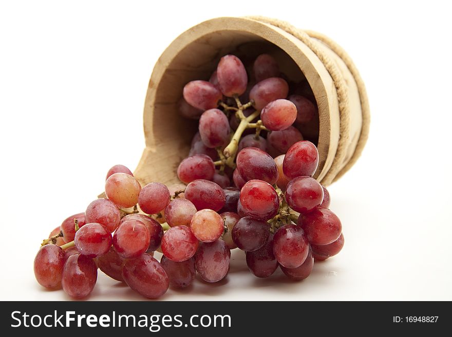 Red grapes in the wood receptacle. Red grapes in the wood receptacle