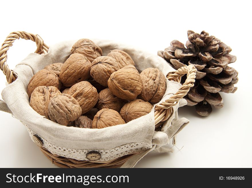 Walnuts in the basket with pine cones