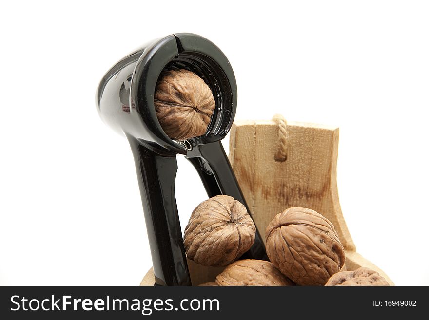 Walnuts and nutcrackers onto white background. Walnuts and nutcrackers onto white background