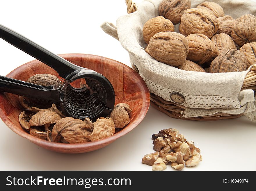 Walnuts in the basket with nutcracker in the bowl