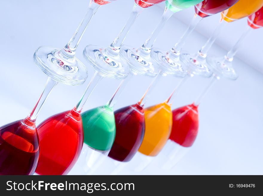 Colored glasses arranged on a glass substrate. Mirror was used as background. Colored glasses arranged on a glass substrate. Mirror was used as background