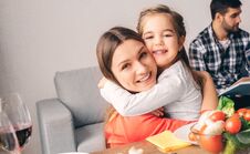 Handsome Mother Embrace Cute Little Daughter Stock Photography