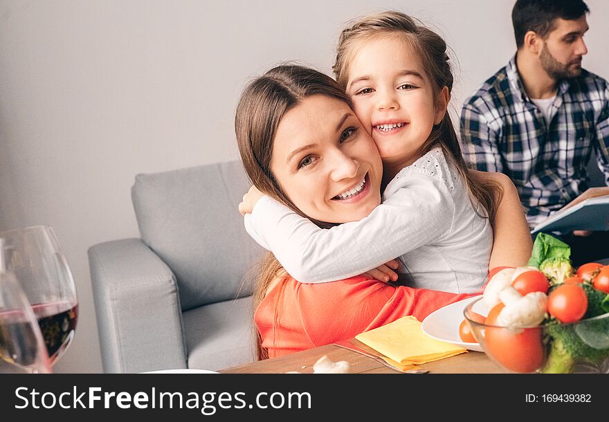 Handsome mother toothy smiling embrace cute little daughter. Love and family concept. Handsome mother toothy smiling embrace cute little daughter. Love and family concept