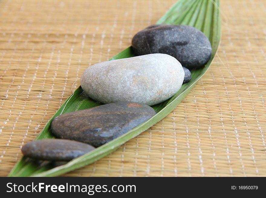 Spa treatment .beautiful spa background.zen stones and leaf on bamboo mat